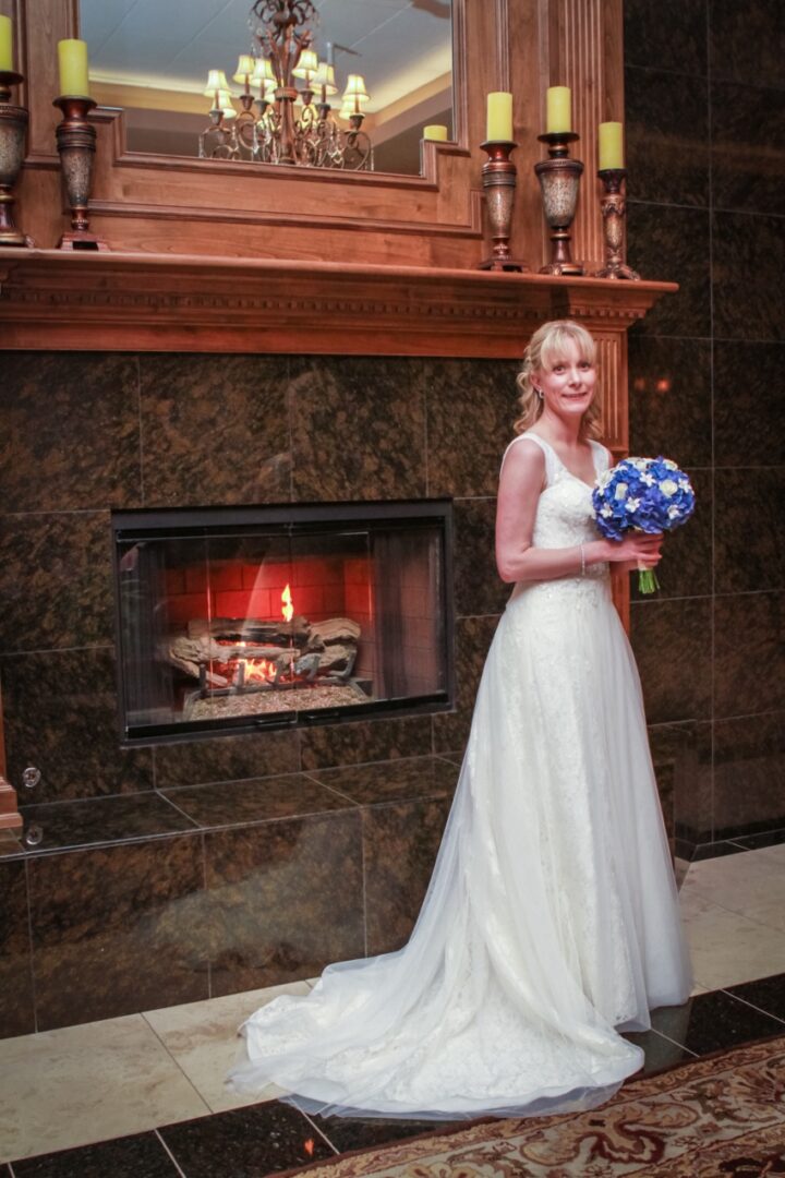 Wedding Dress photos in front of a fireplace