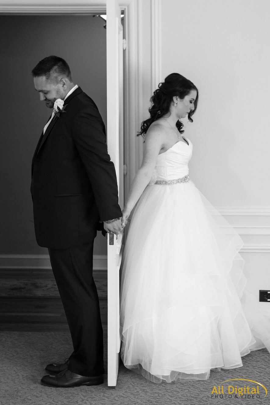 Bride And Groom Holding Hands Around Door